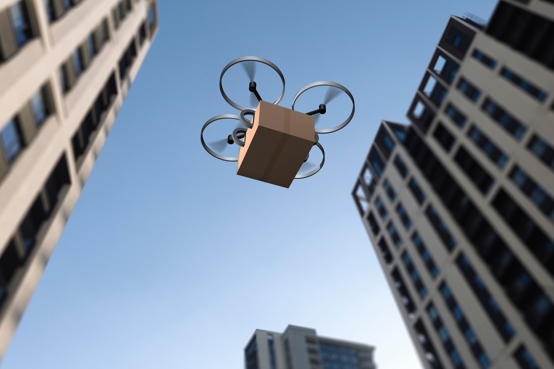Drone delivers a package in an urban environment on a clear day with tall buildings surrounding the area