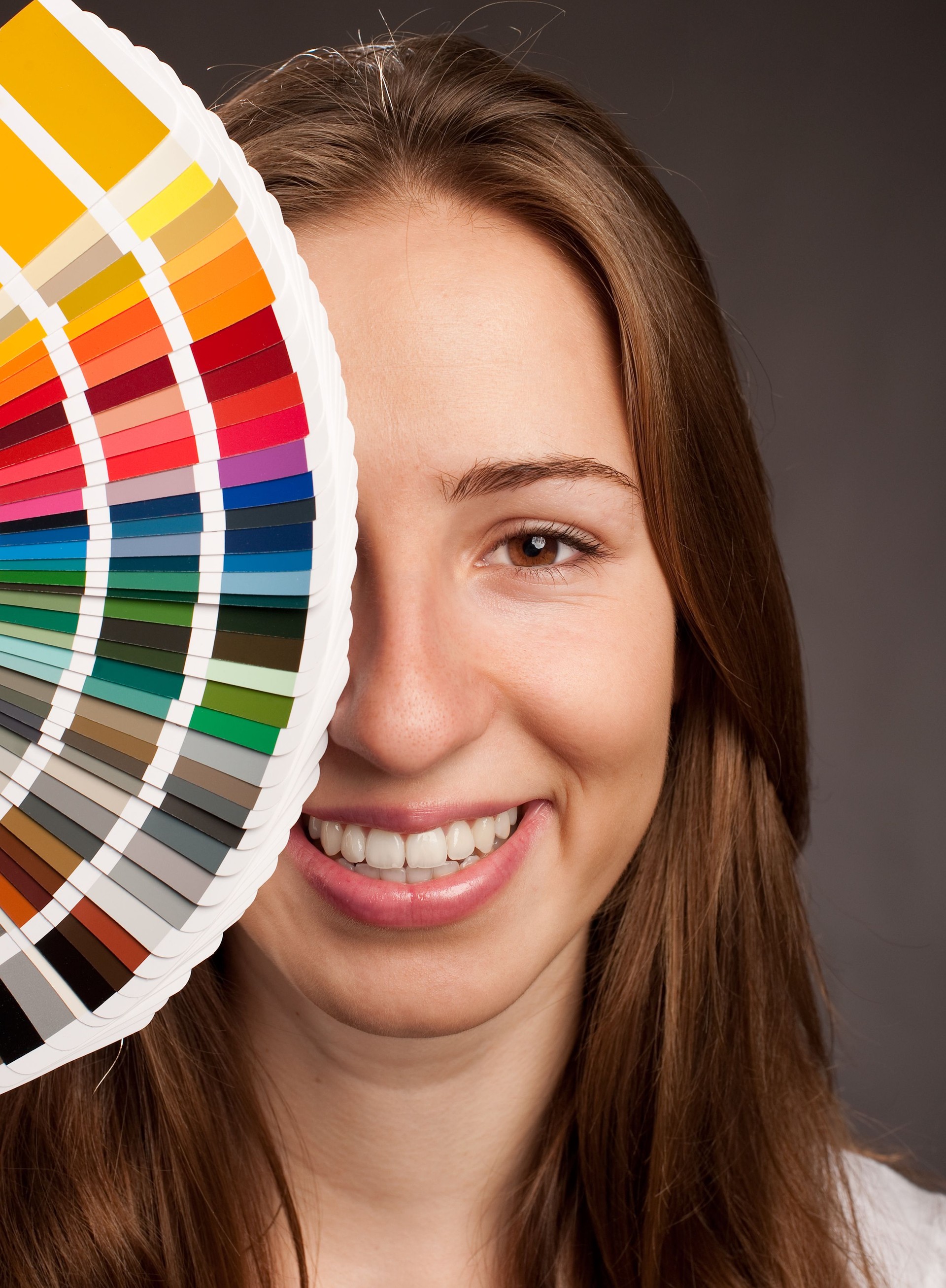 young woman holding a pantone palette